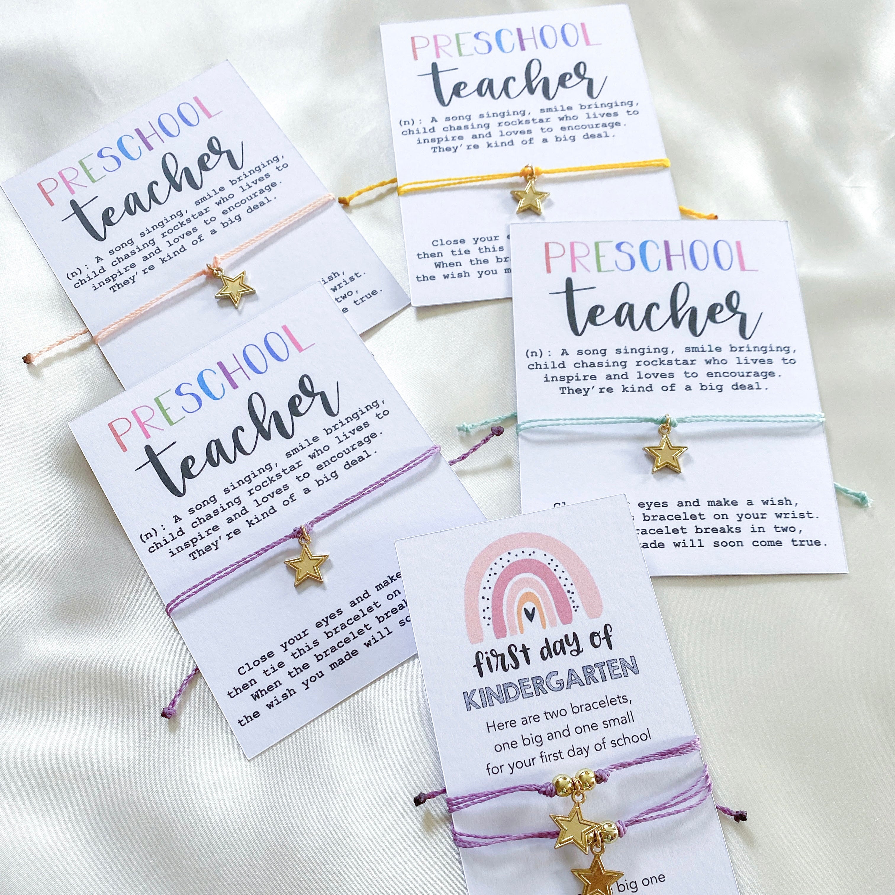 Custom colorful string bracelets with gold star charms on cards for preschool teachers