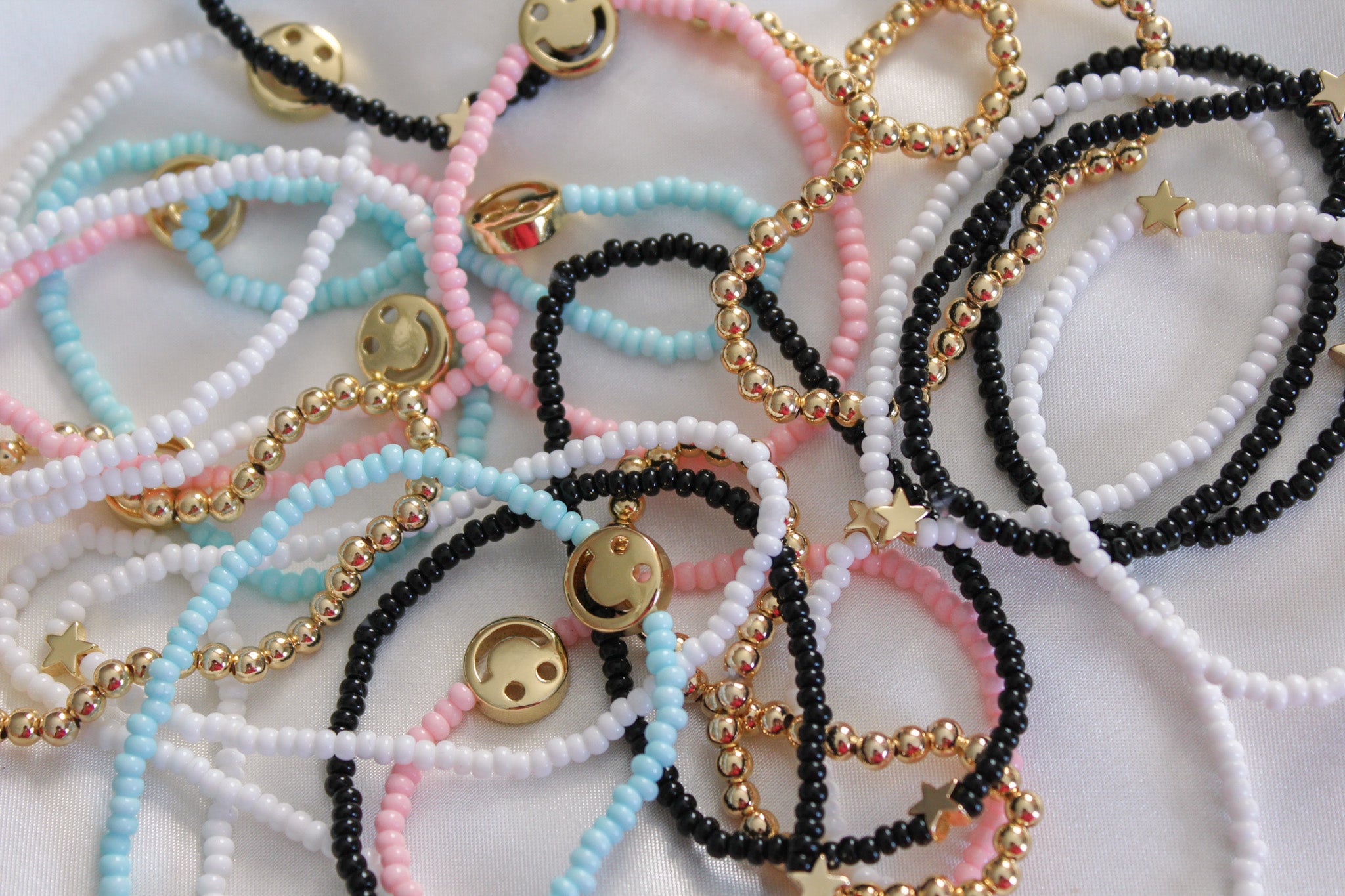 Colorful seed bead bracelets with gold smiley and star charms